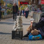 A senior street vendor selling goods on a sunny day in Sulaymaniyah, Iraq.